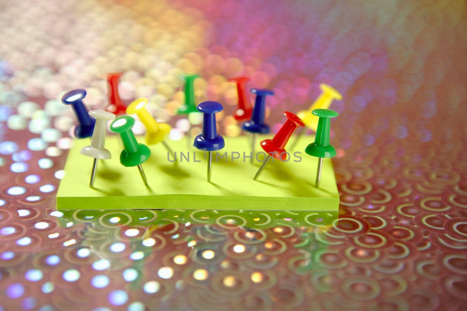 adhesive color notes with colorful pin over holographic background