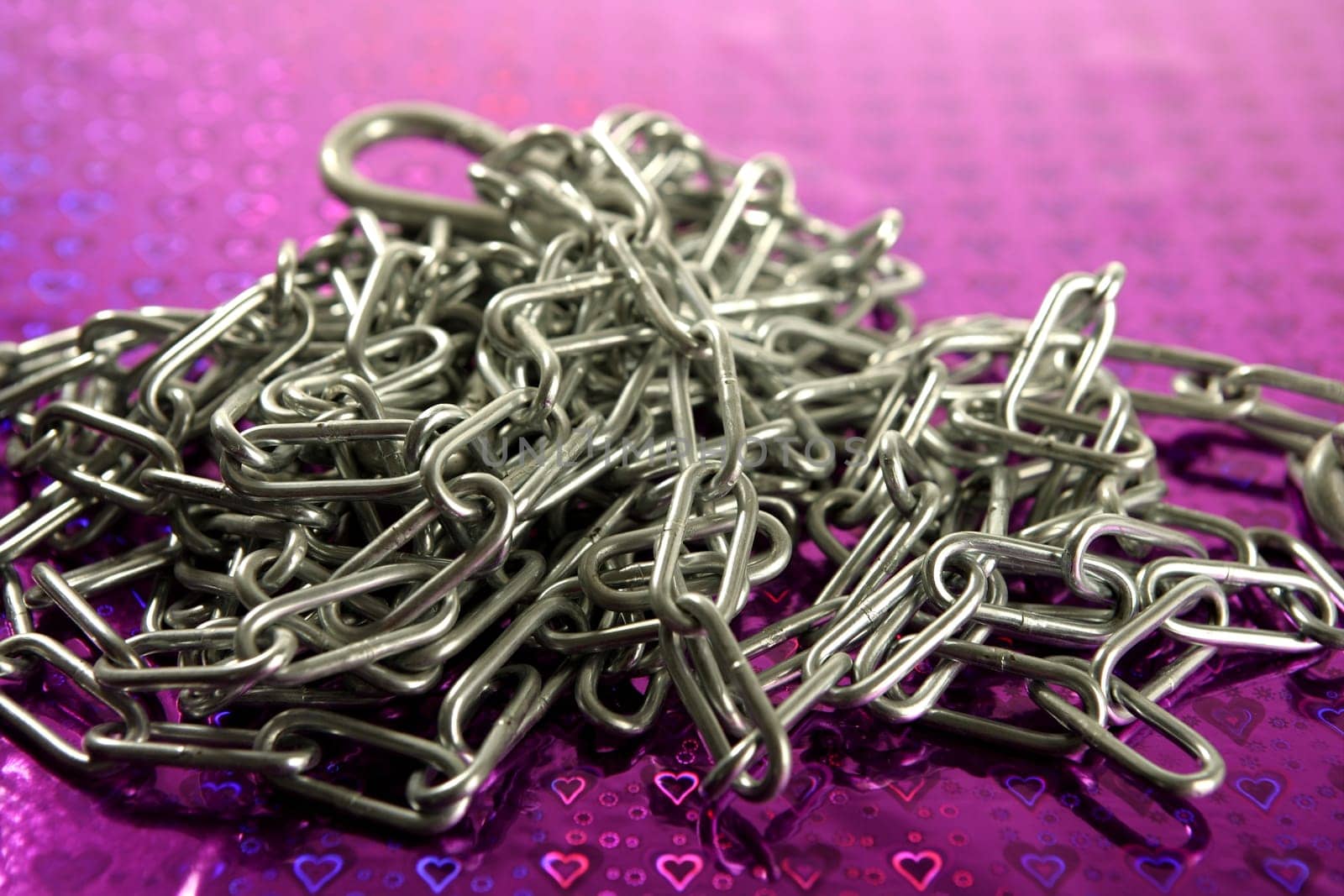 Steel chain mess studio shot over purple background
