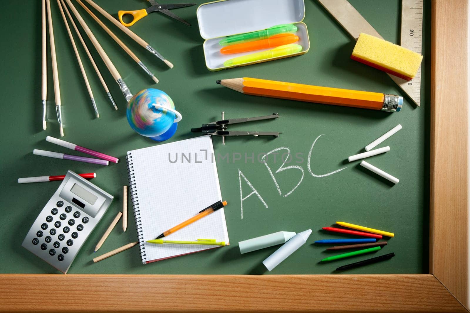 back to school concept with ABC written in school in green color blackboard