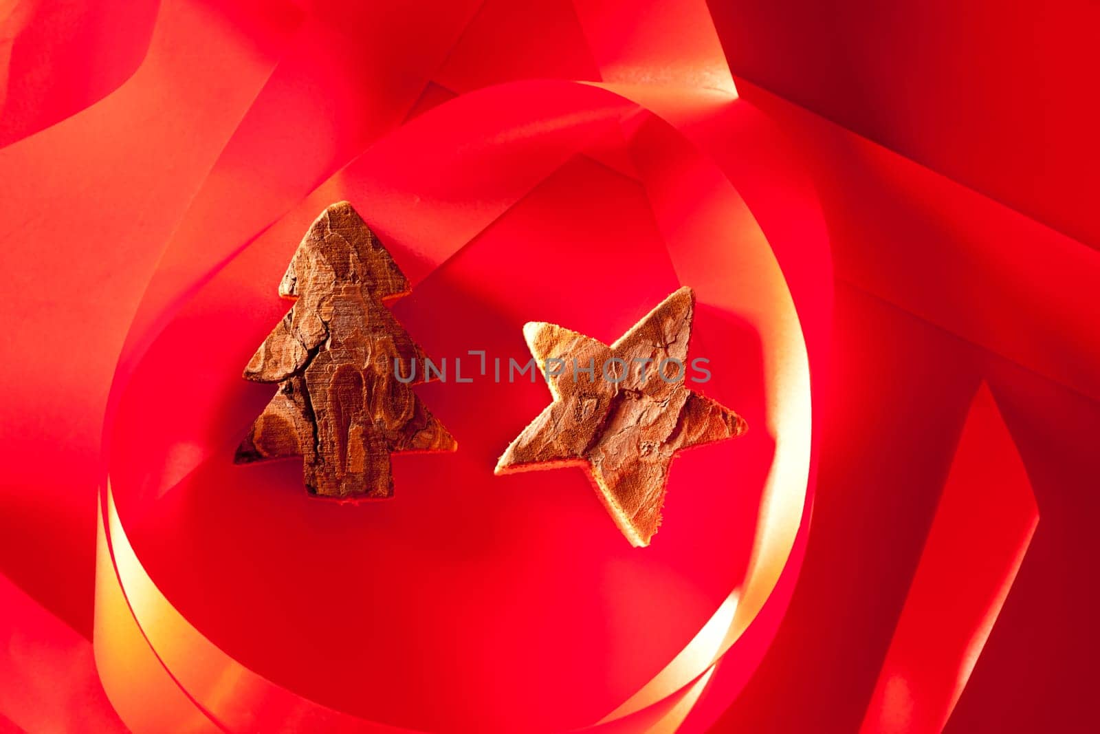 Christmas tree and star of tree bark on red background and ribbon