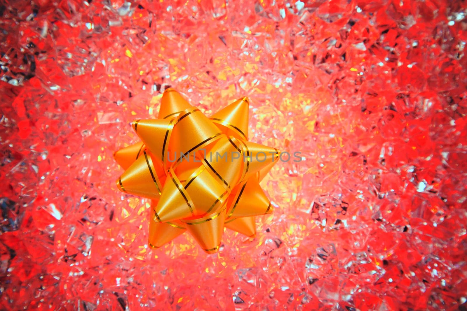 christmas gift golden ribbon on red ice background