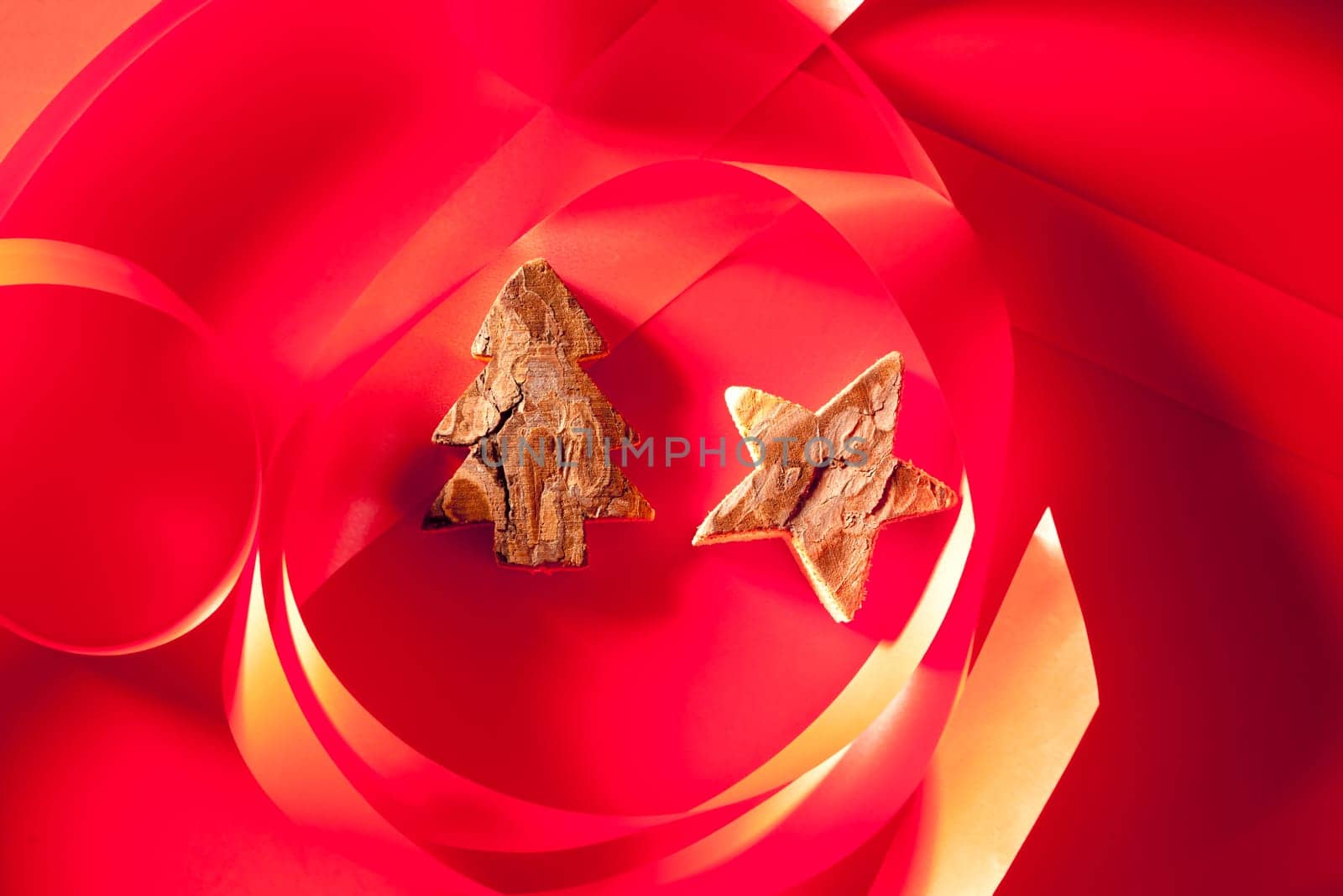 Christmas tree and star of tree bark on red background and ribbon