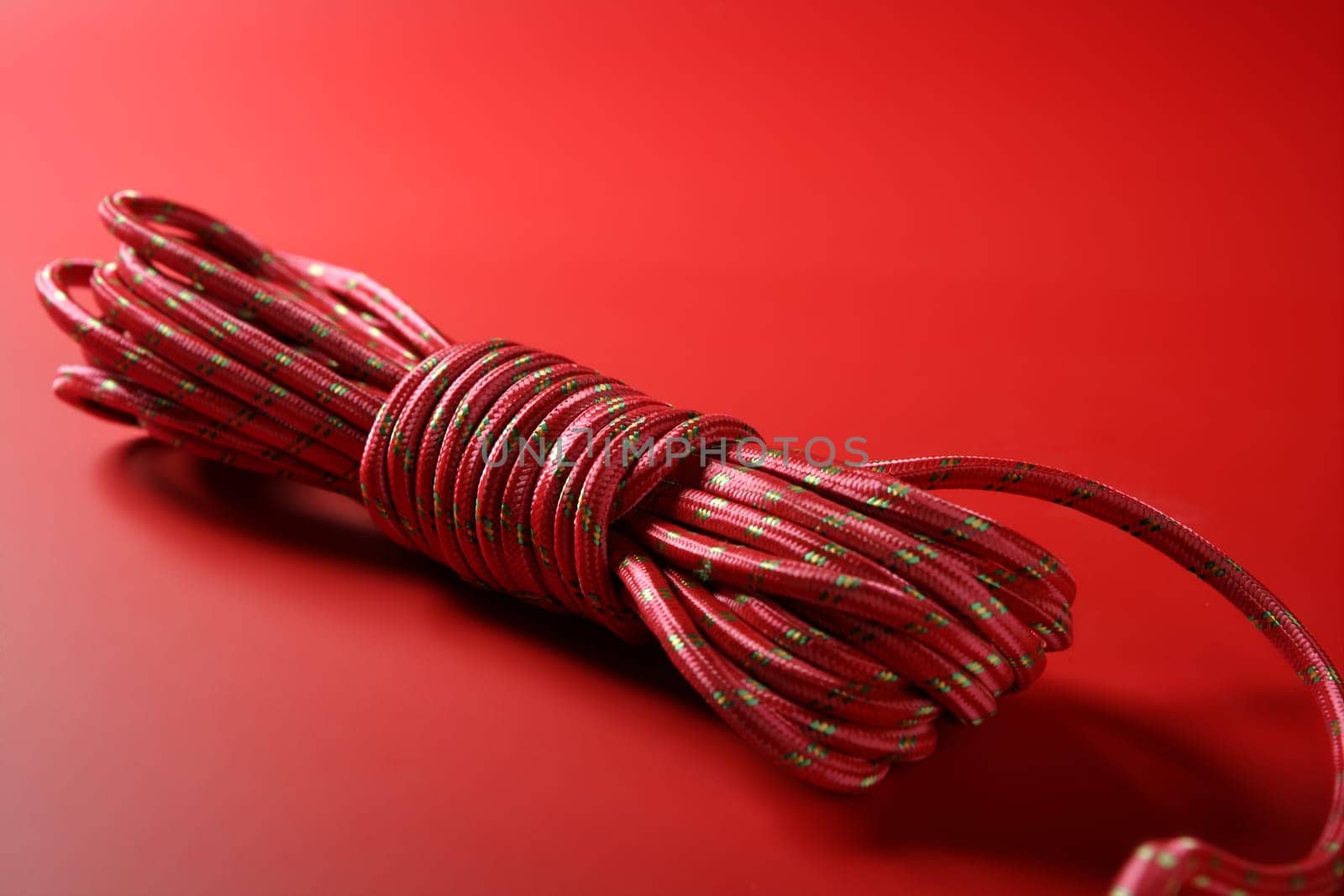 Red thread spool on monochrome background