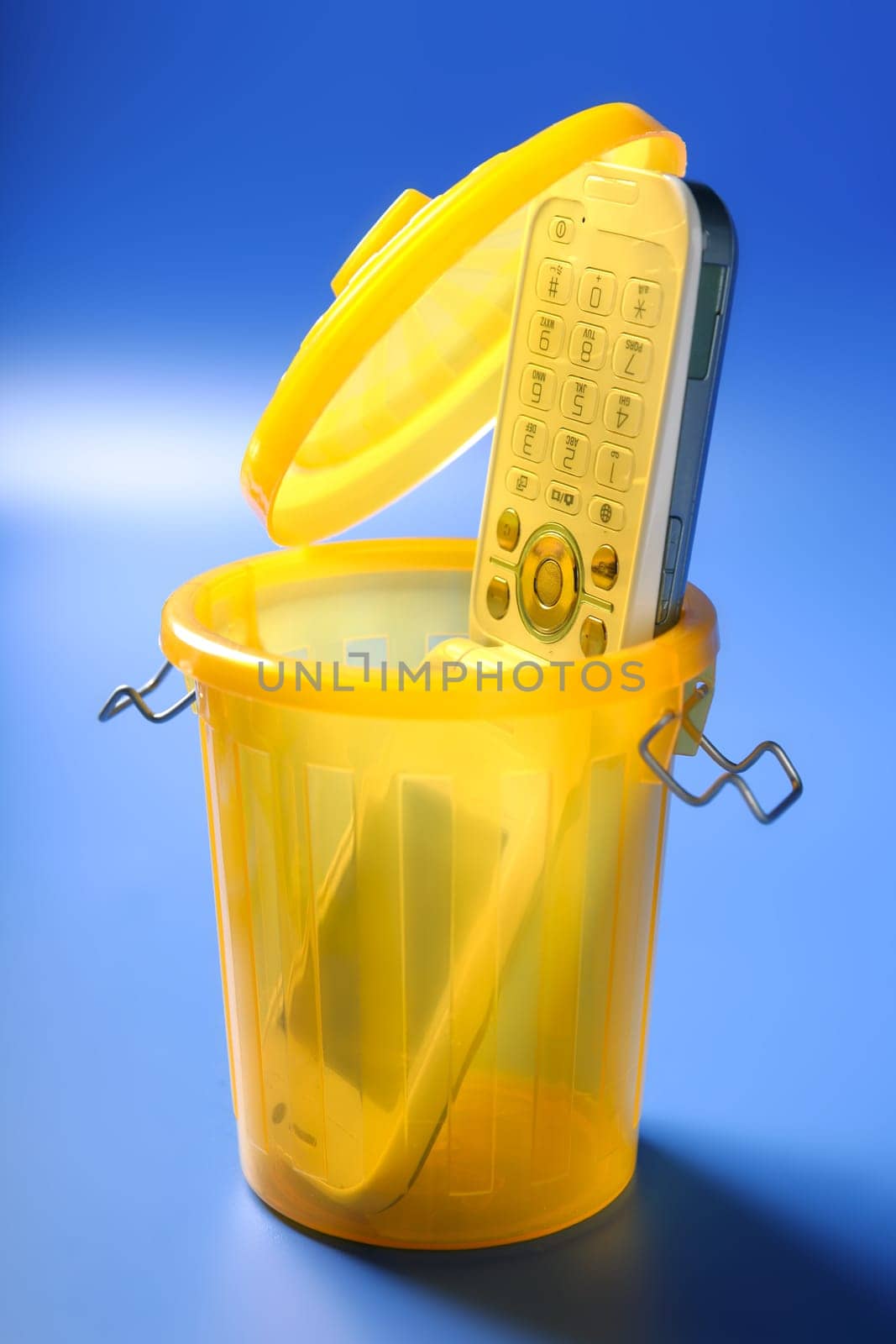 Mobil cell phone on the trash, fed up of communication metaphor