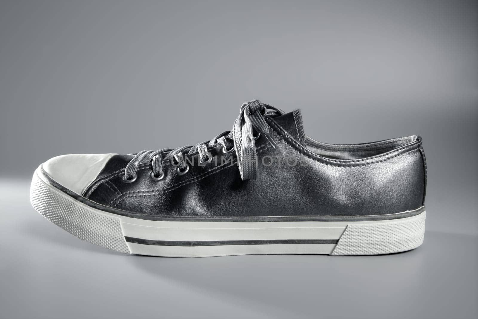 Silver gray sport shoe side view studio shot