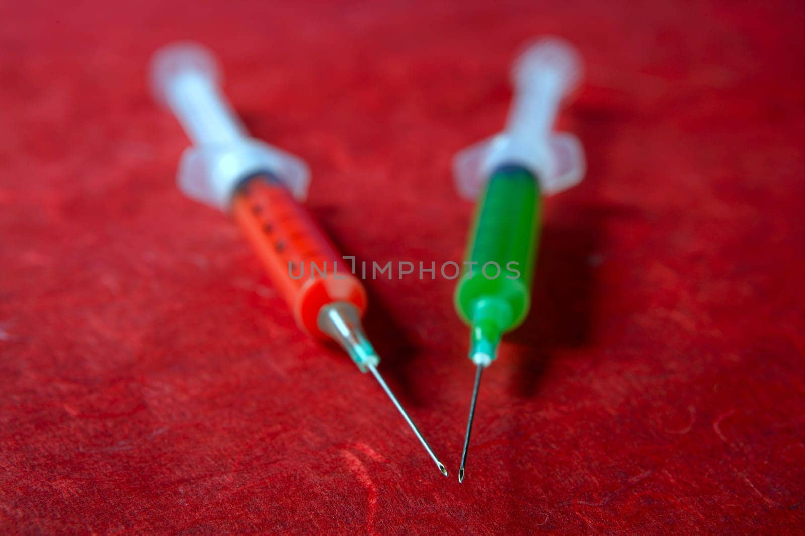 Two red and green syringe, health, addiction, medical research metaphor