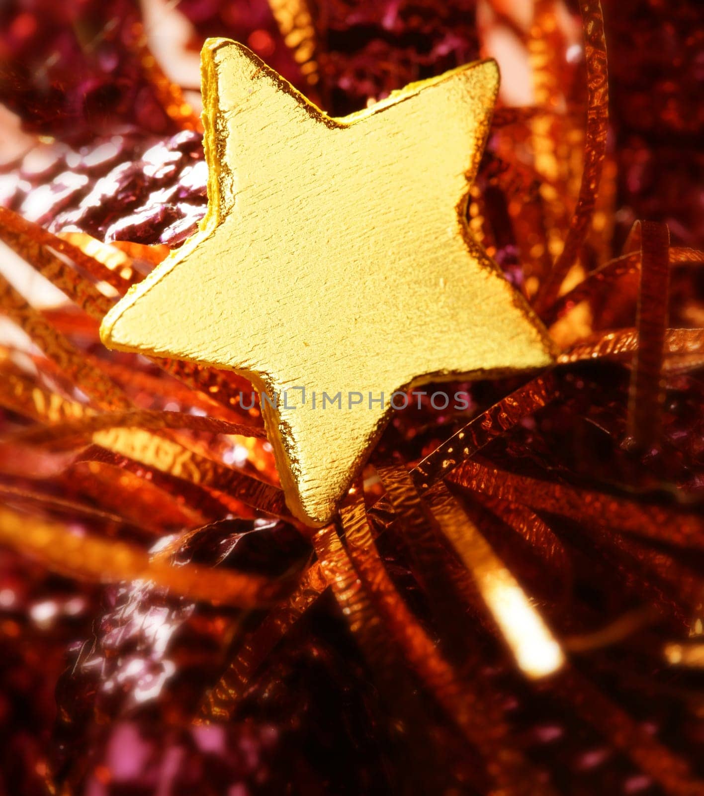 Christmas golden decoration with gold star over red background