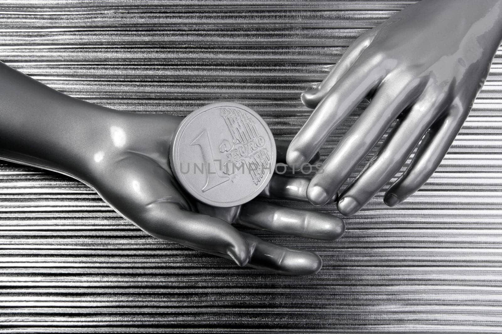 silver euro coins in futuristic robot gray metallic hands bank metaphor