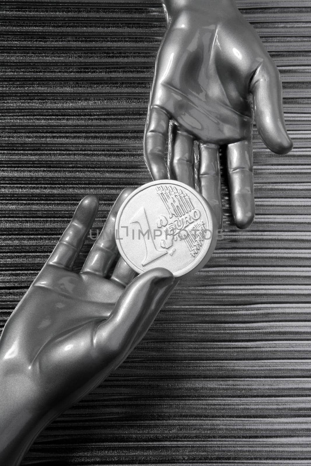 silver euro coins in futuristic robot gray metallic hands bank metaphor