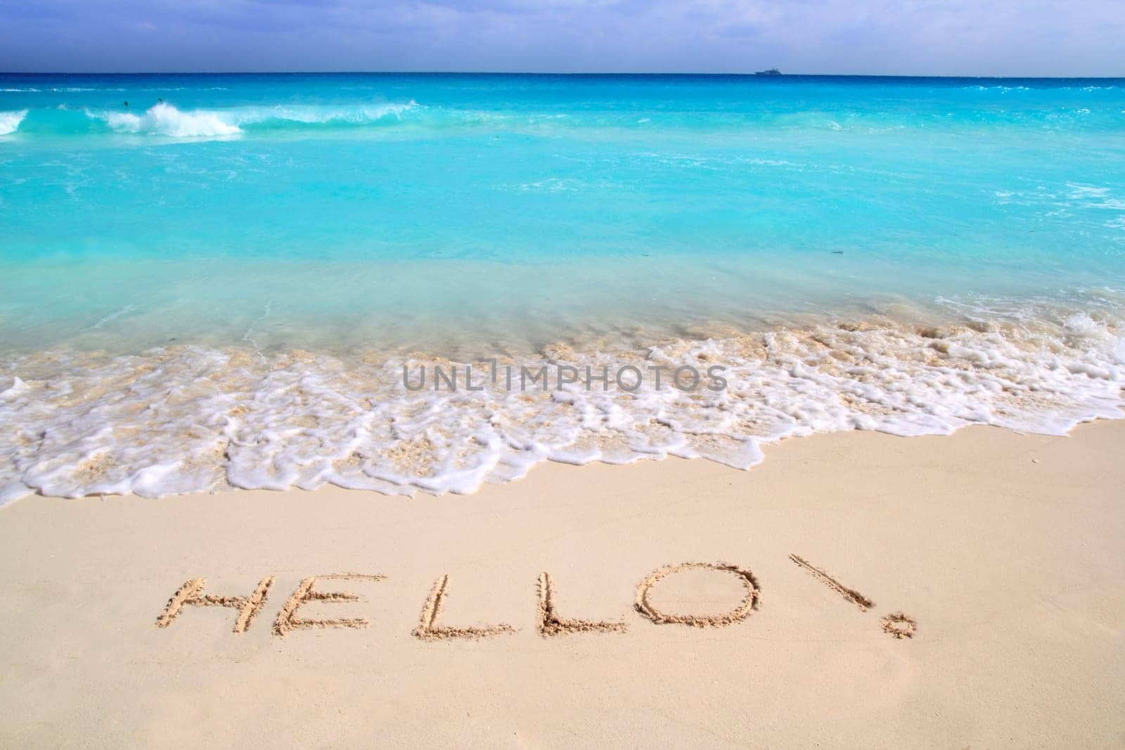 Hello message spell written in tropical beach sand Caribbean turquoise sea