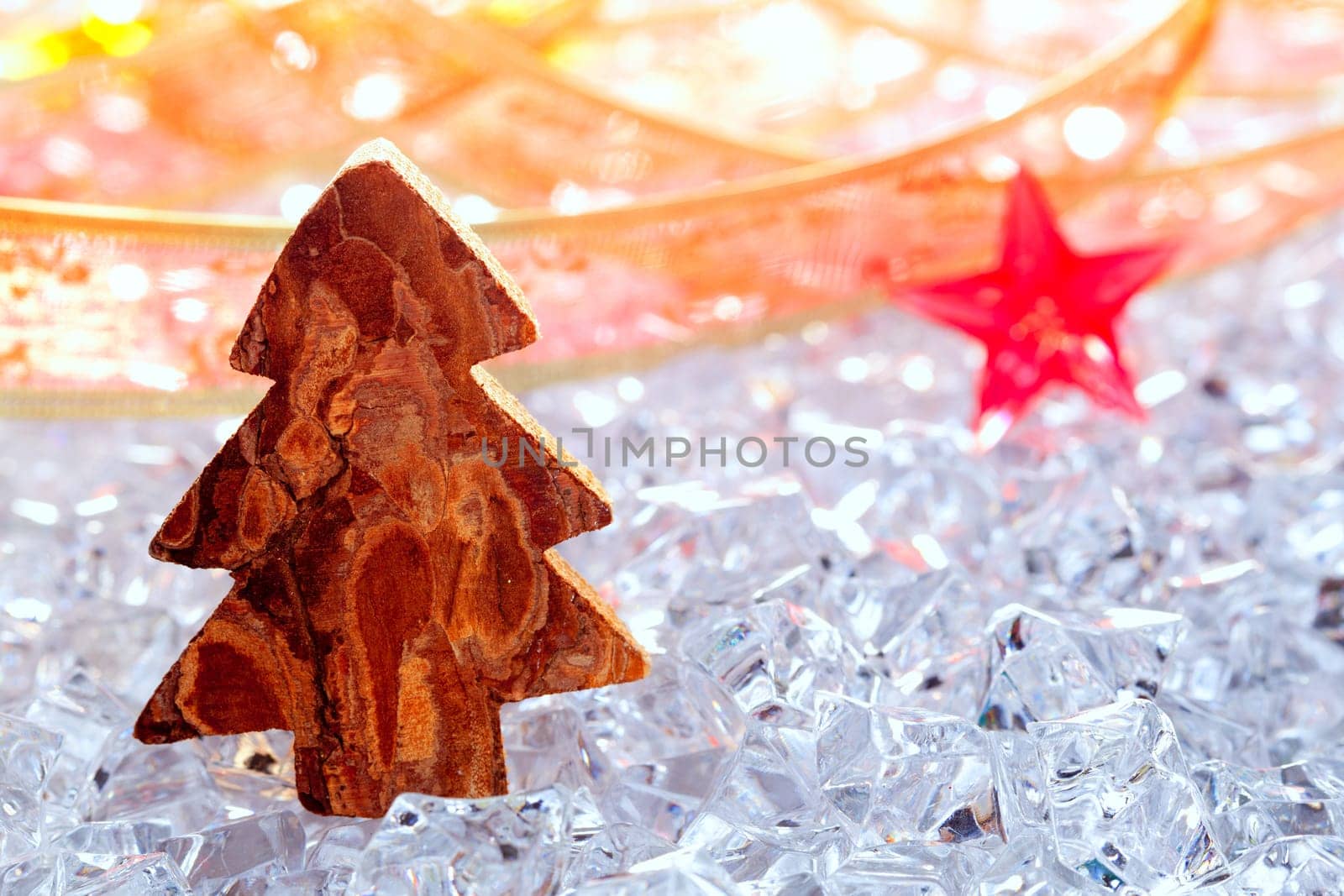 christmas tree with bark wood on winter ice ribbon and stars