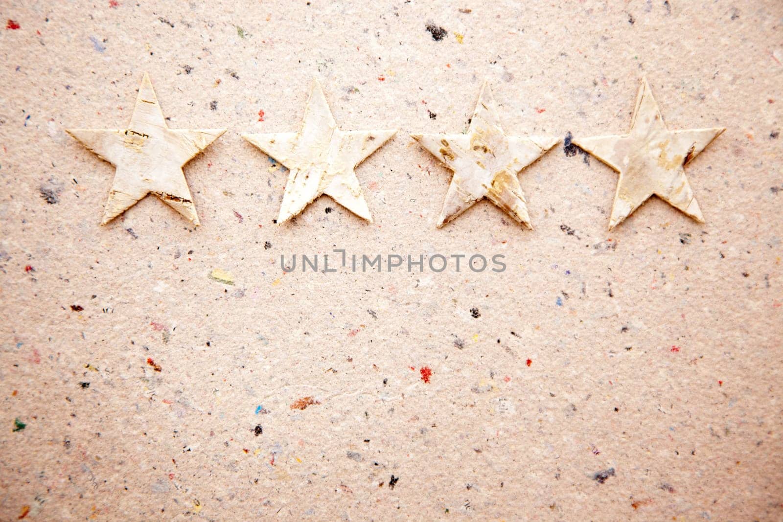 christmas stars on recycled paper background as an ecology metaphor
