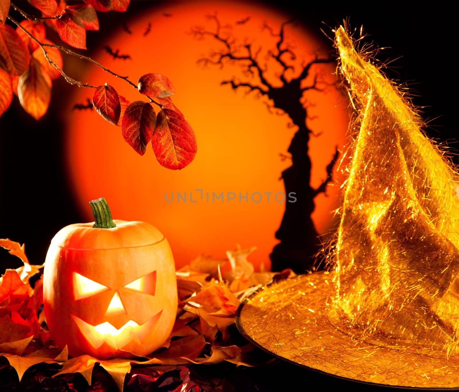 Halloween orange pumpkin lantern with autumn leaves