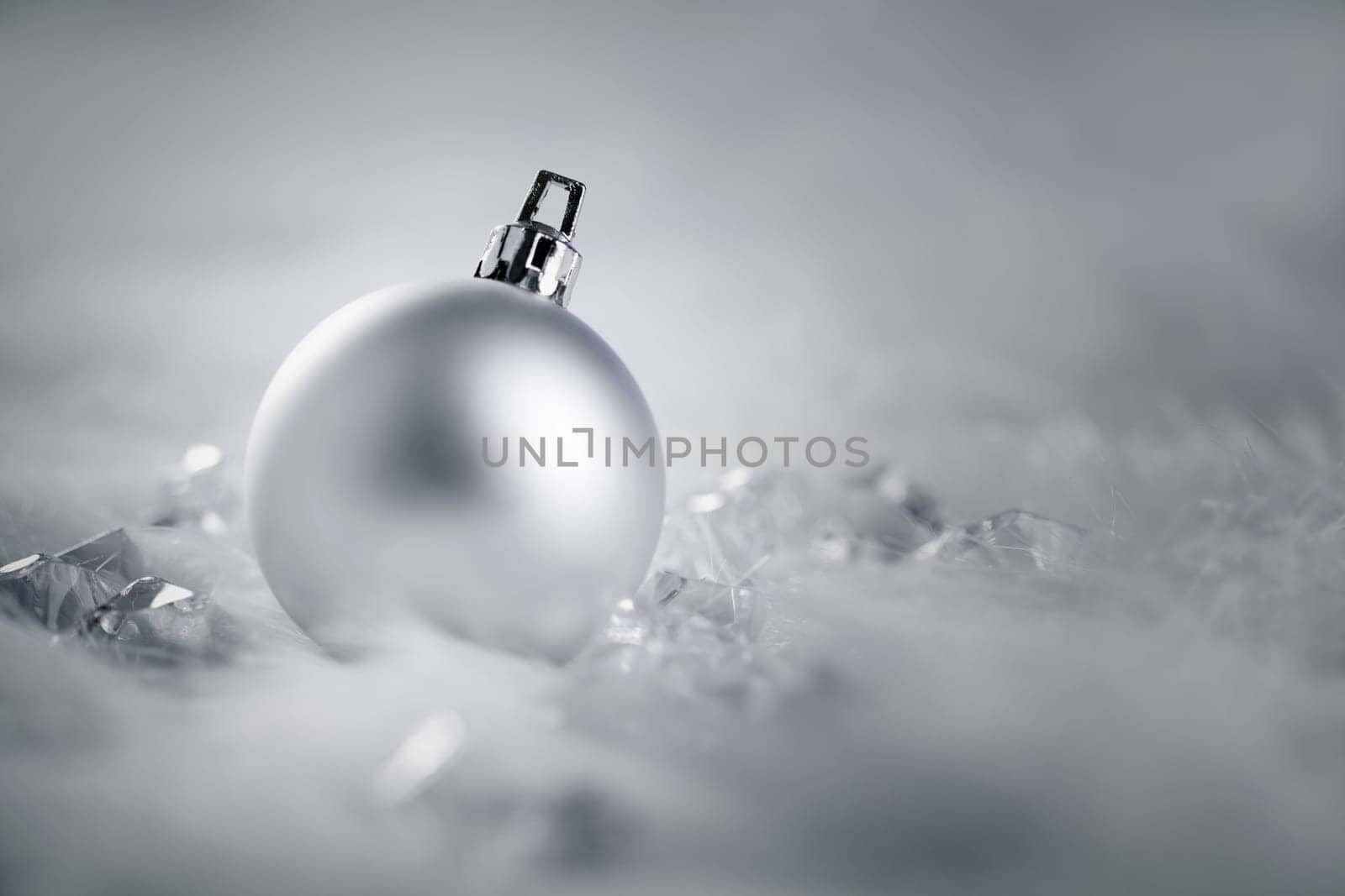 christmas silver bauble on fur snow and ice cold winter