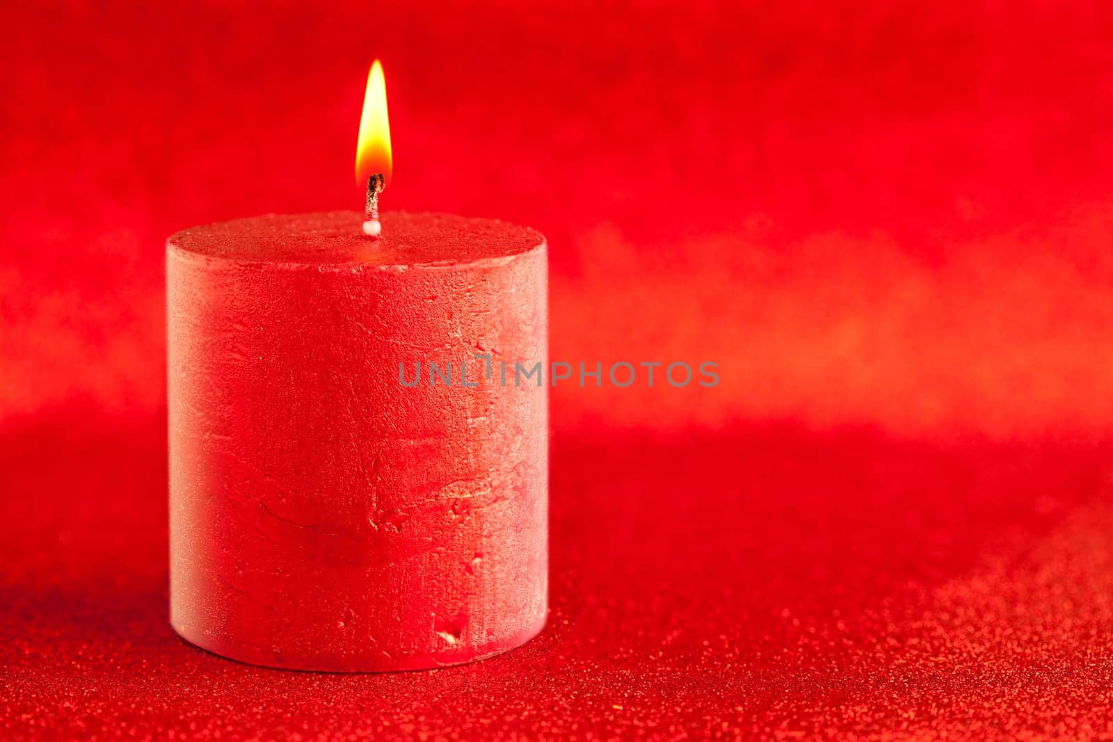 christmas candle candlelight on red glitter background