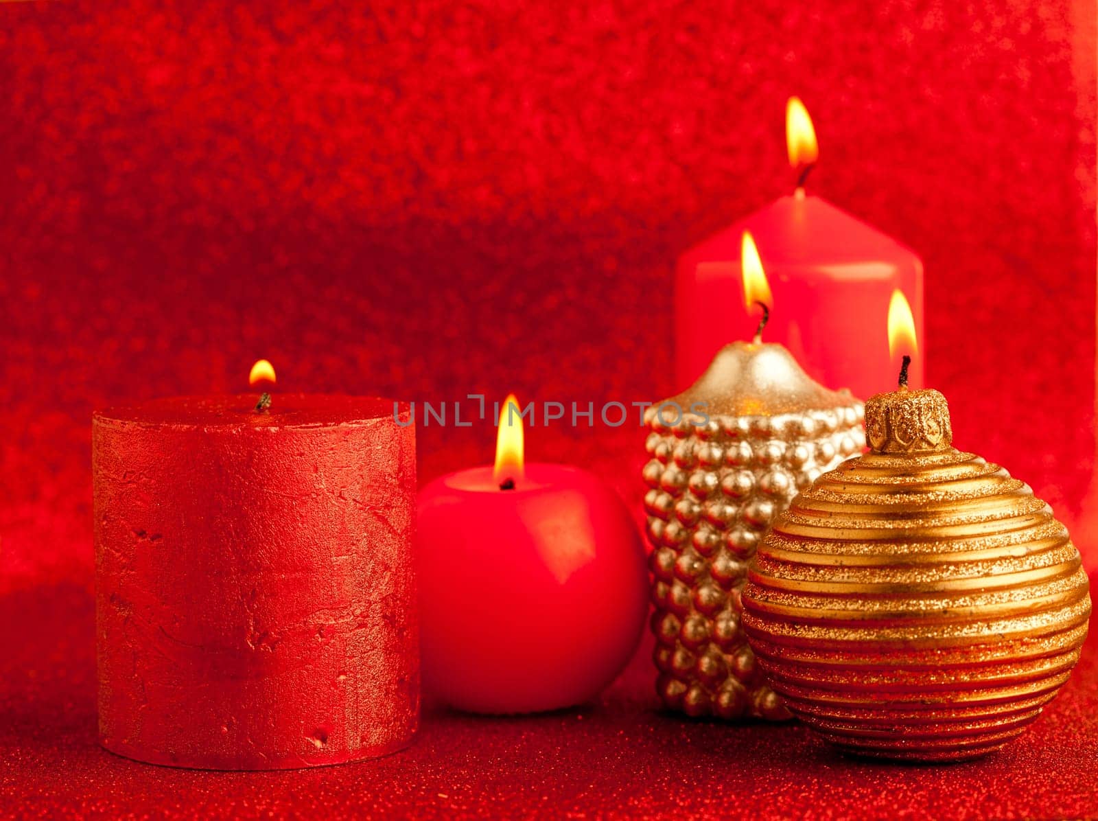 christmas candles group on red glitter background