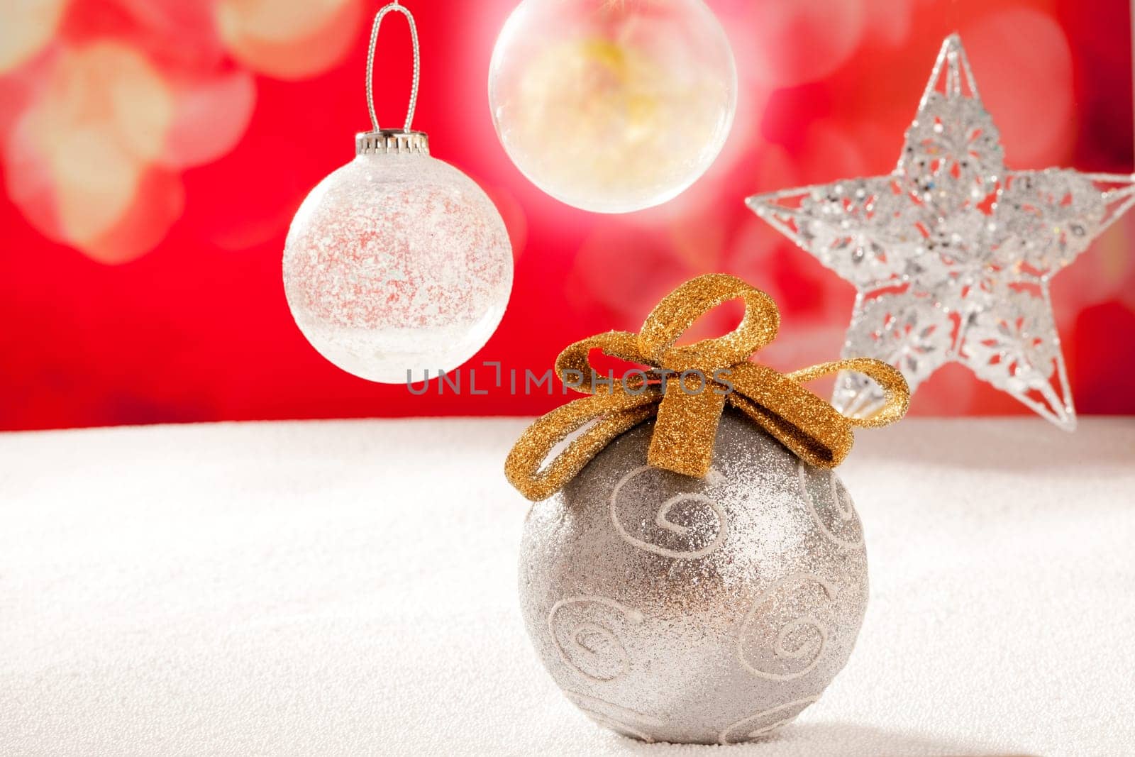 Christmas silver bauble and star on snow red background