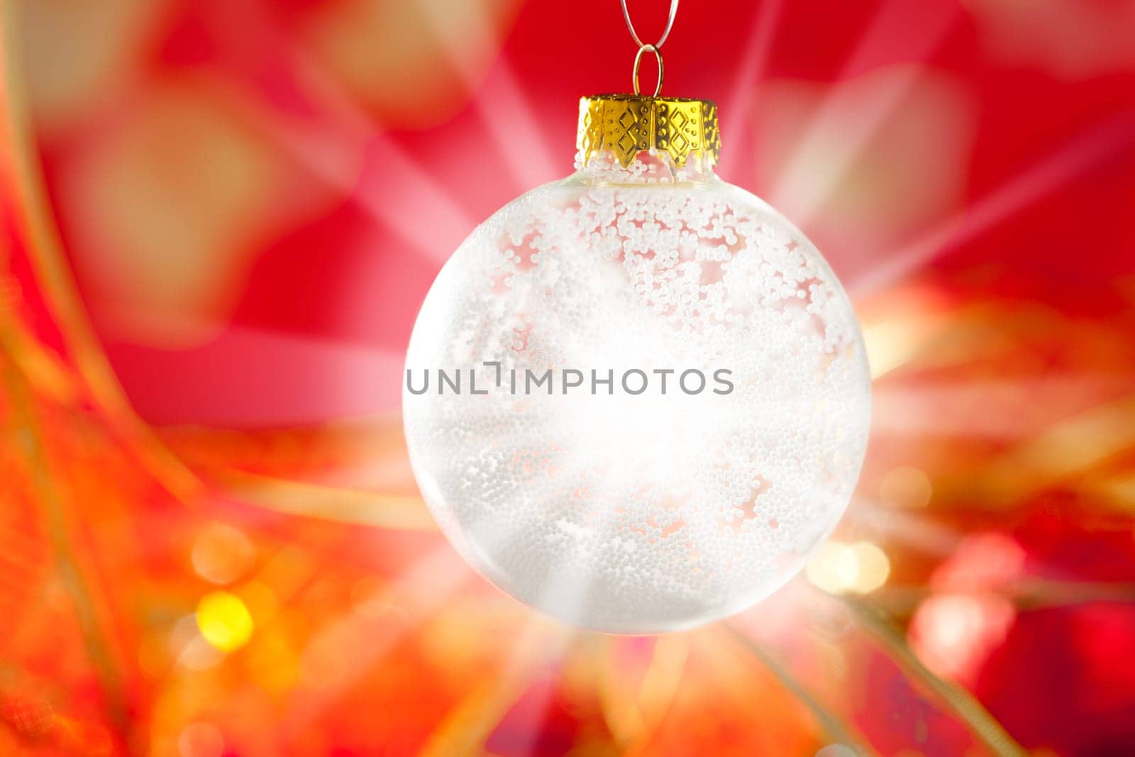 Christmas card snow bauble with snow and flare star light on red background