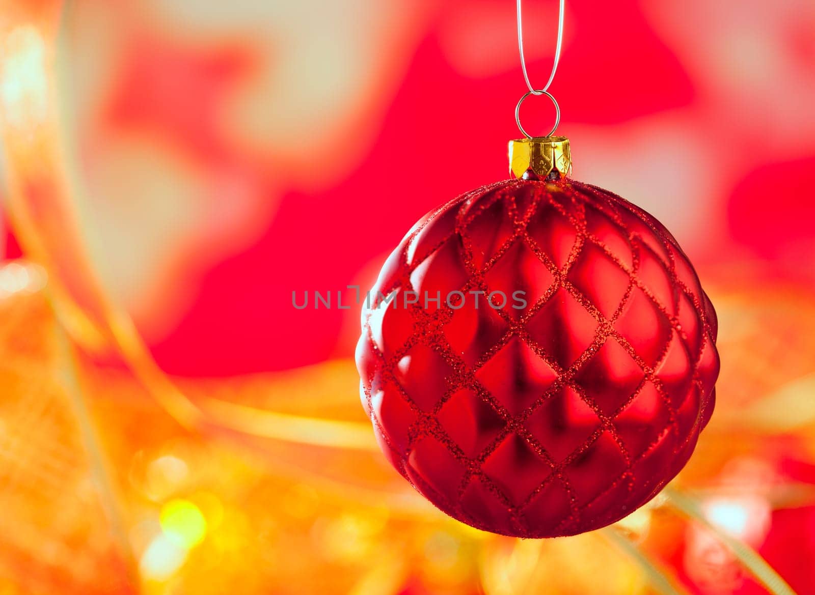 Christmas card of red capiton bauble on blur background