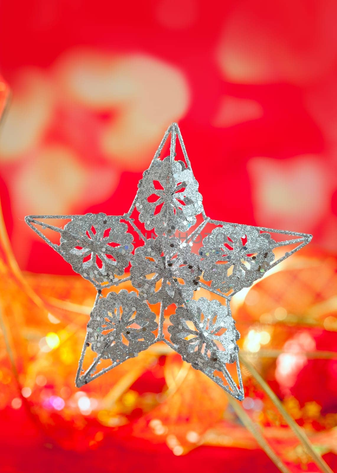 Christmas card of silver star and red blur background