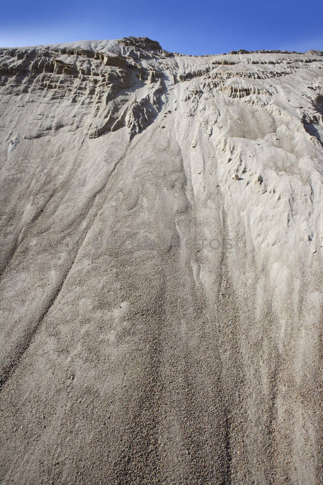 white sand quarry mound like moon mountain blue sky