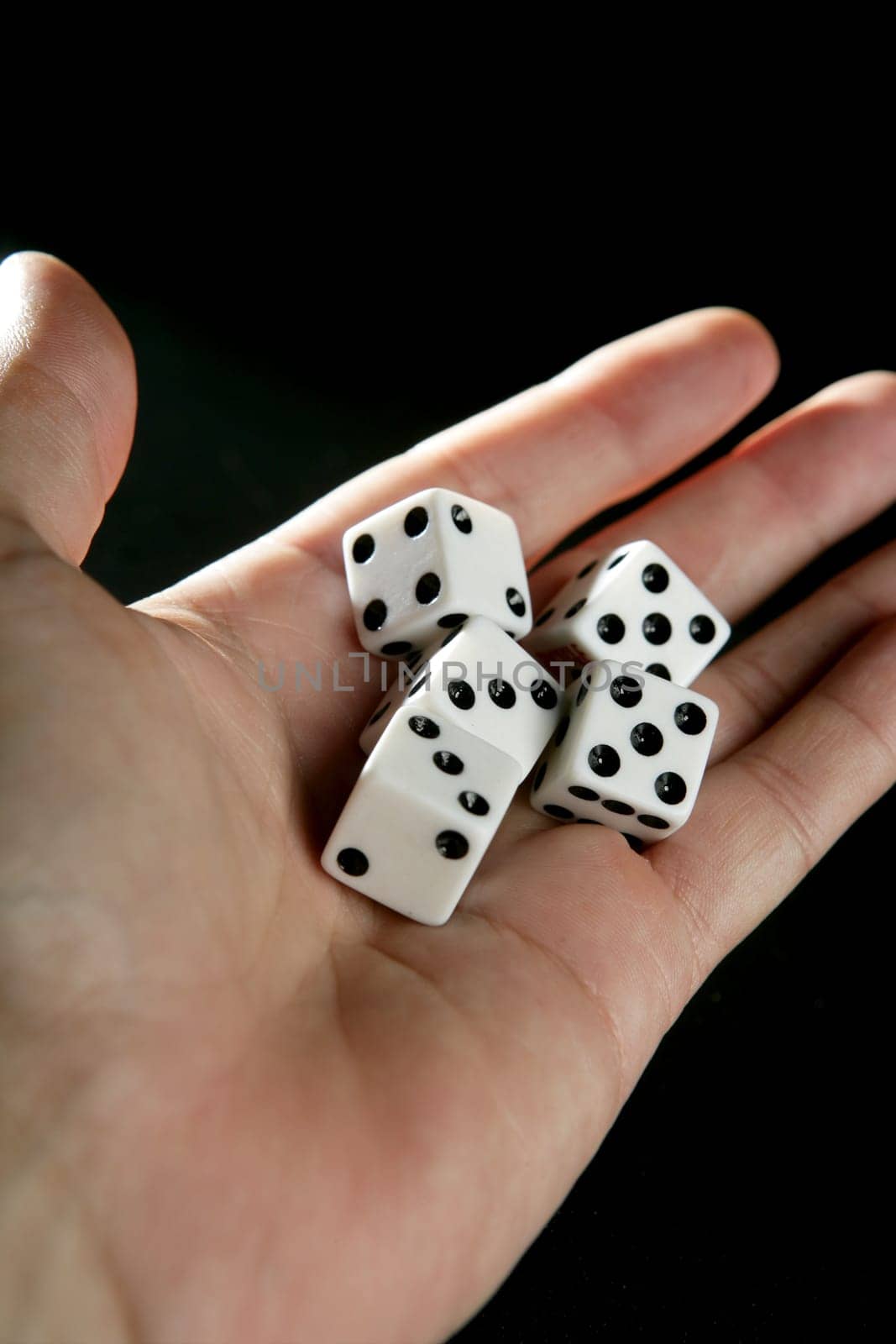 Gambler five dices, luck metaphor over black background