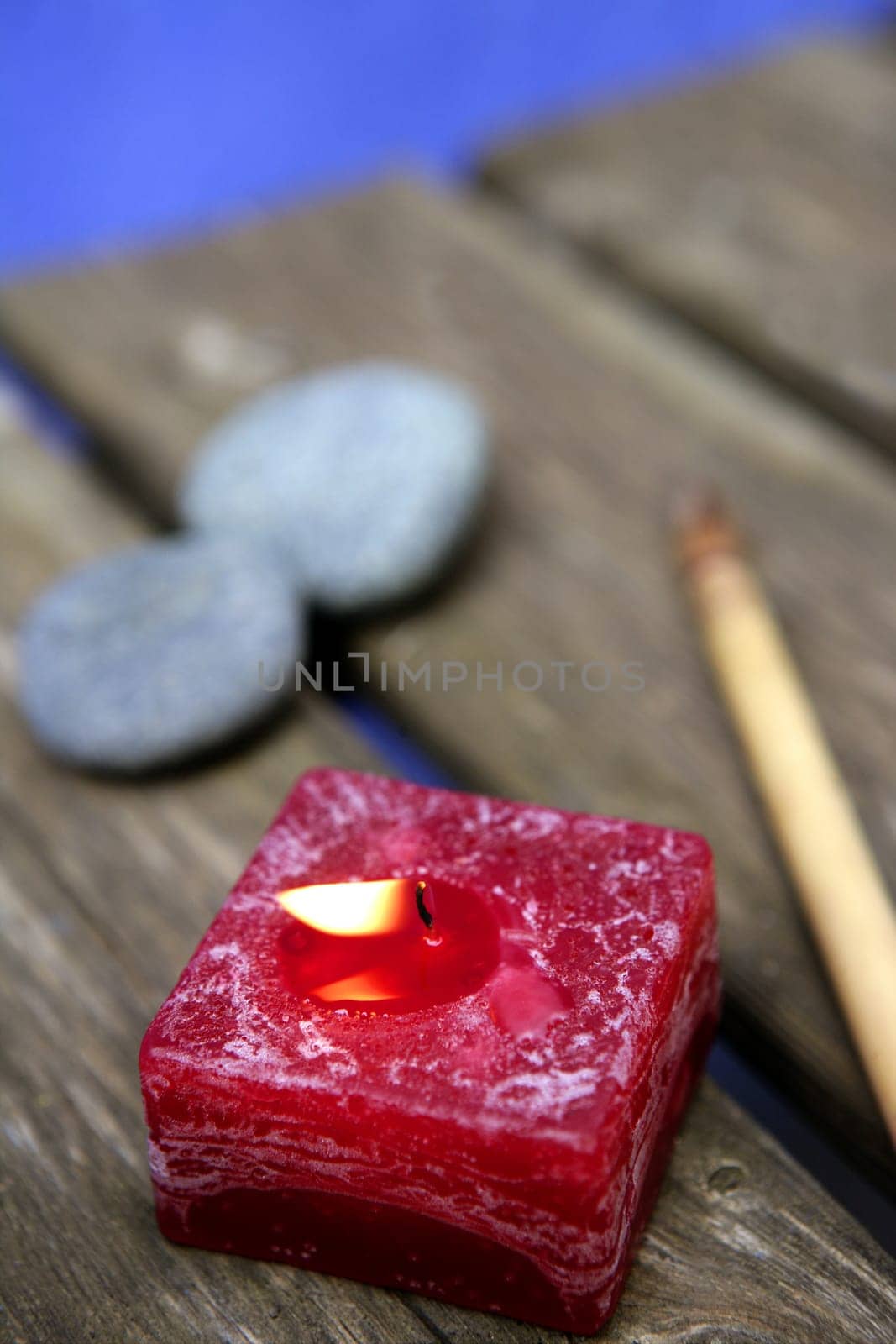 Natural theraphy, stones, and candles over wood