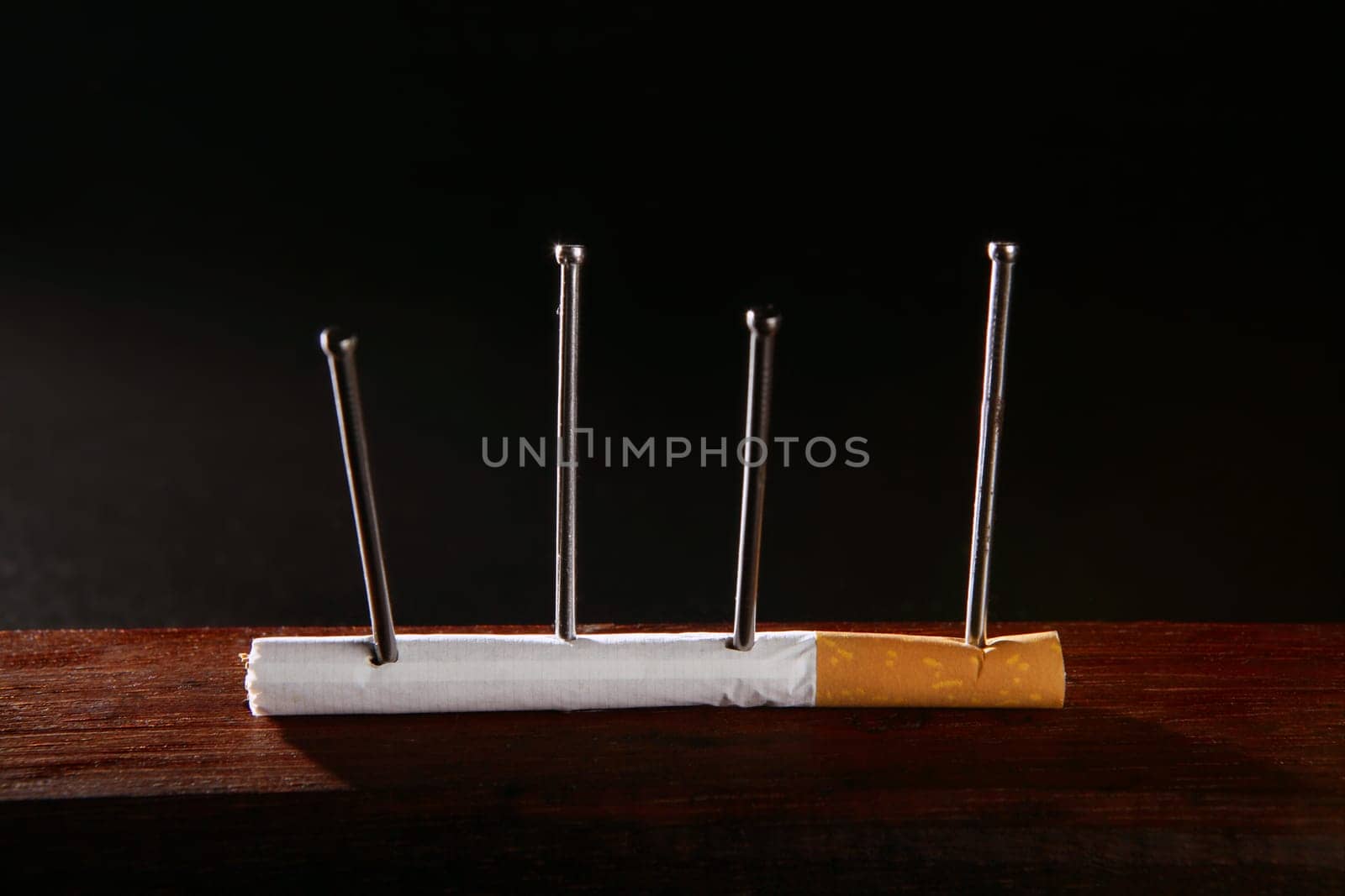 Nicotine tobacco addiction concept metaphor cigarette and nails