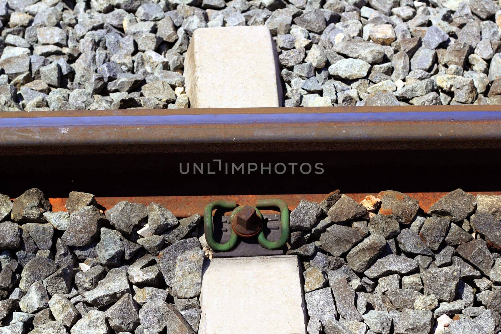 iron rusty train railway detail over dark stones rail way