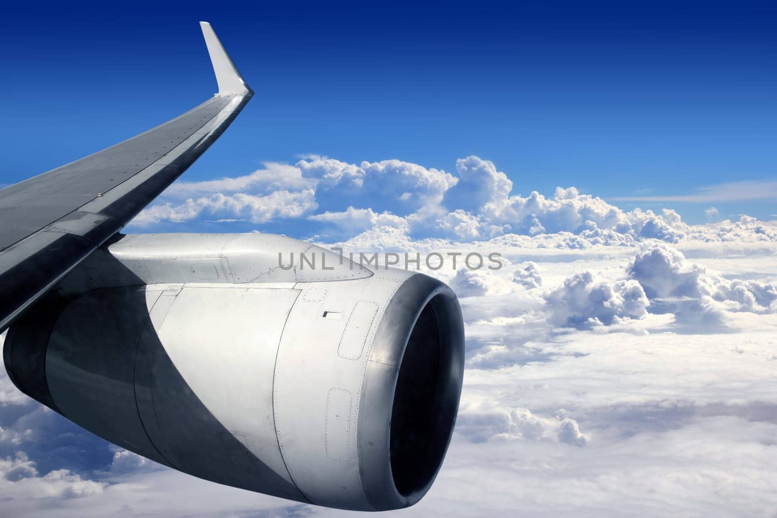 airplane wing aircraft turbine flying blue sky white clouds
