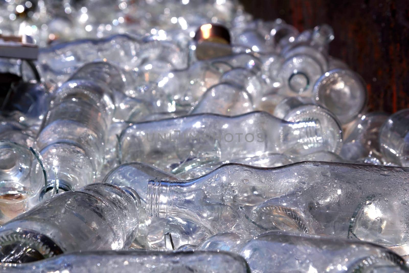 ecological recycling glass bottles in messy container