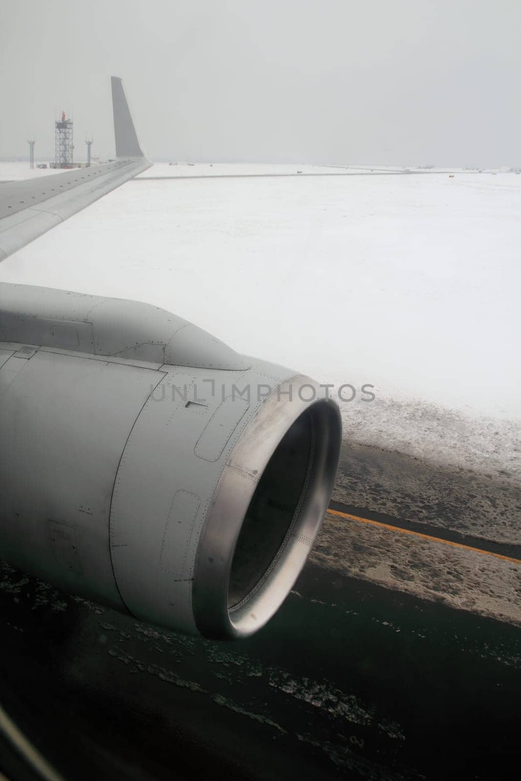 aircraft wing with turbine landing on winter snow runway