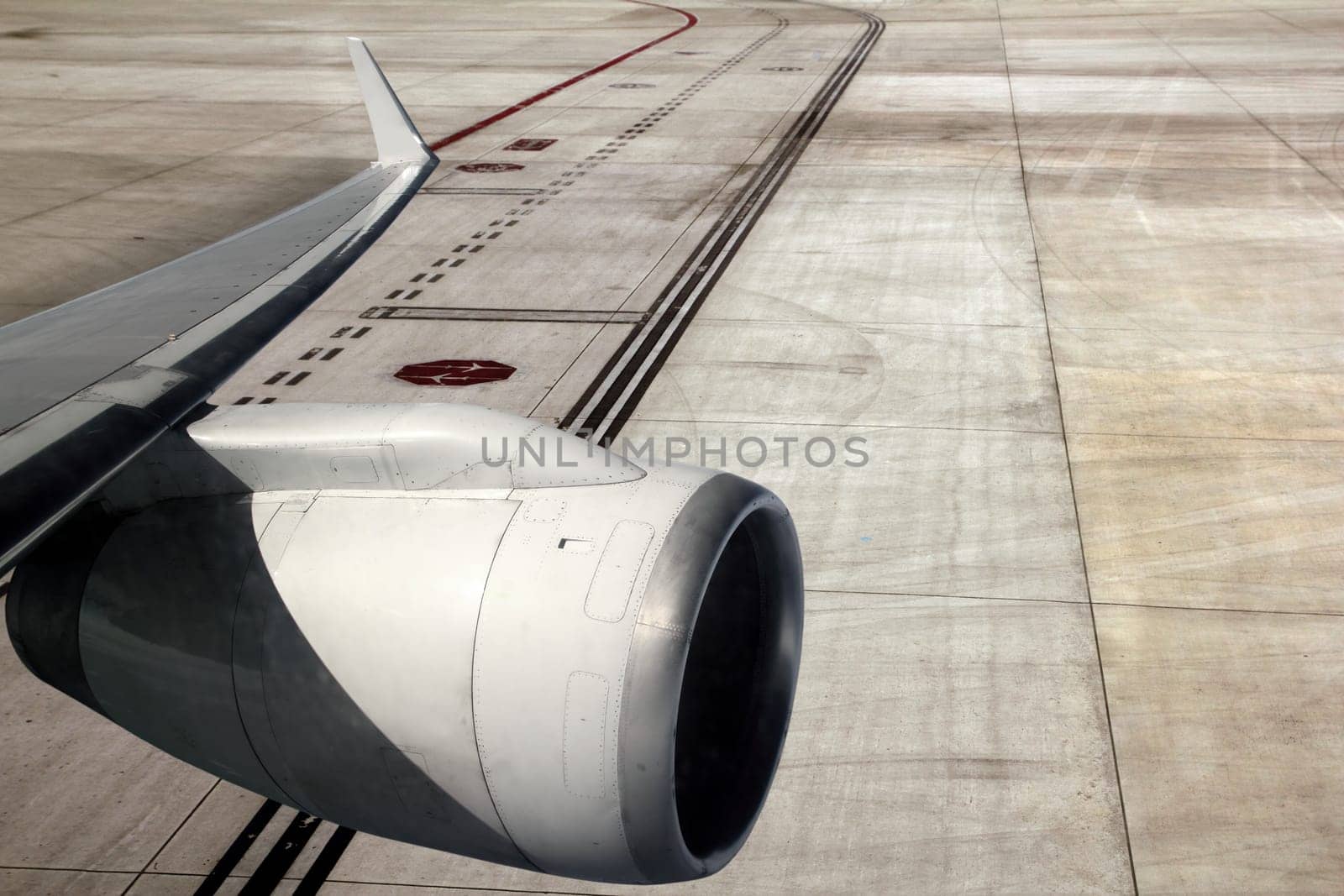 airplane wing with turbine landing on runway road