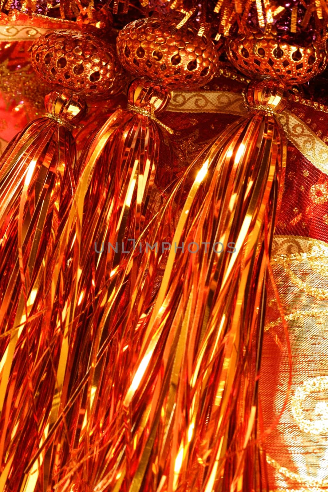 Golden christmas macro decoration, red background, studio shot