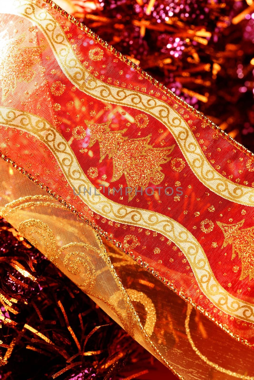 Golden christmas macro decoration, red background, studio shot