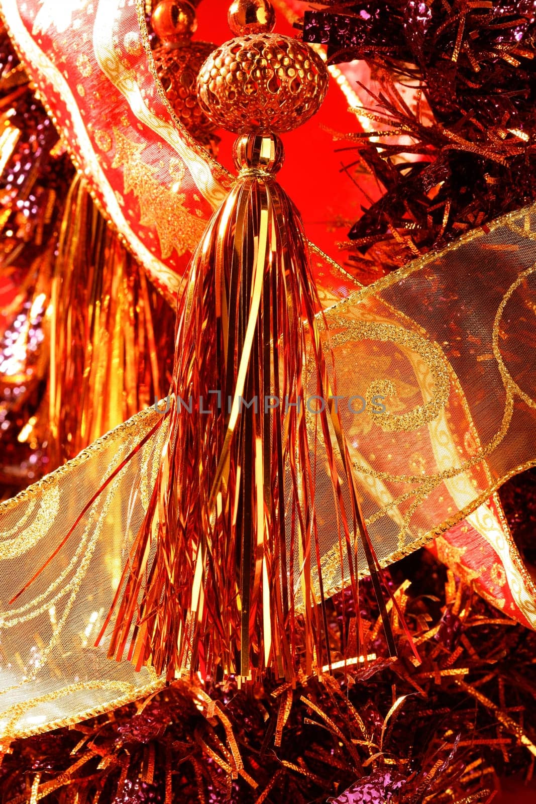 Golden christmas macro decoration, red background, studio shot