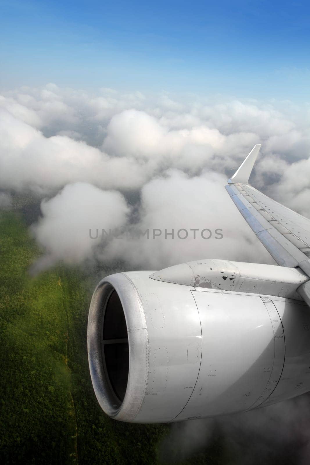 airplane wing aircraft turbine flying jungle bottom white clouds