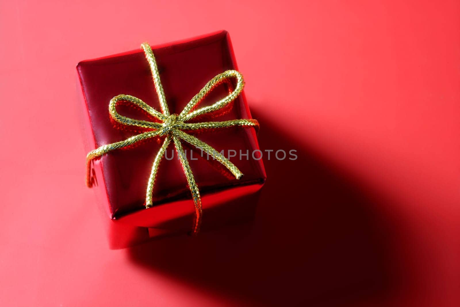 Christmas present, gift over red studio background