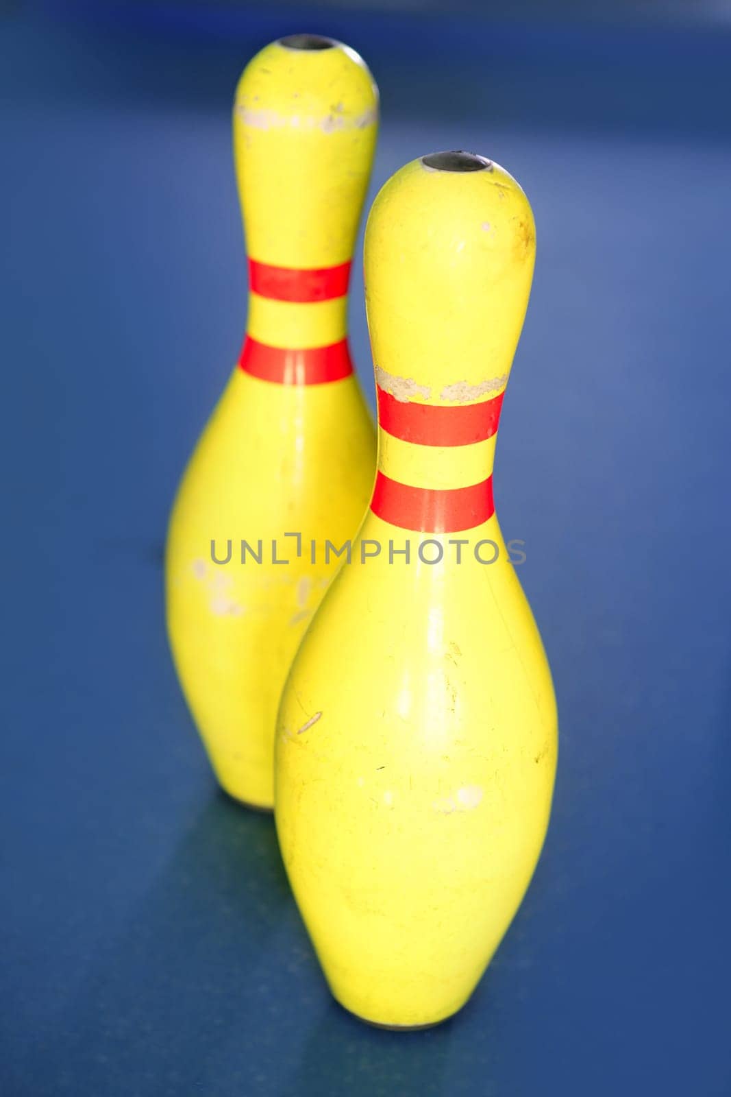 Bowling in yellow color still life blue background image