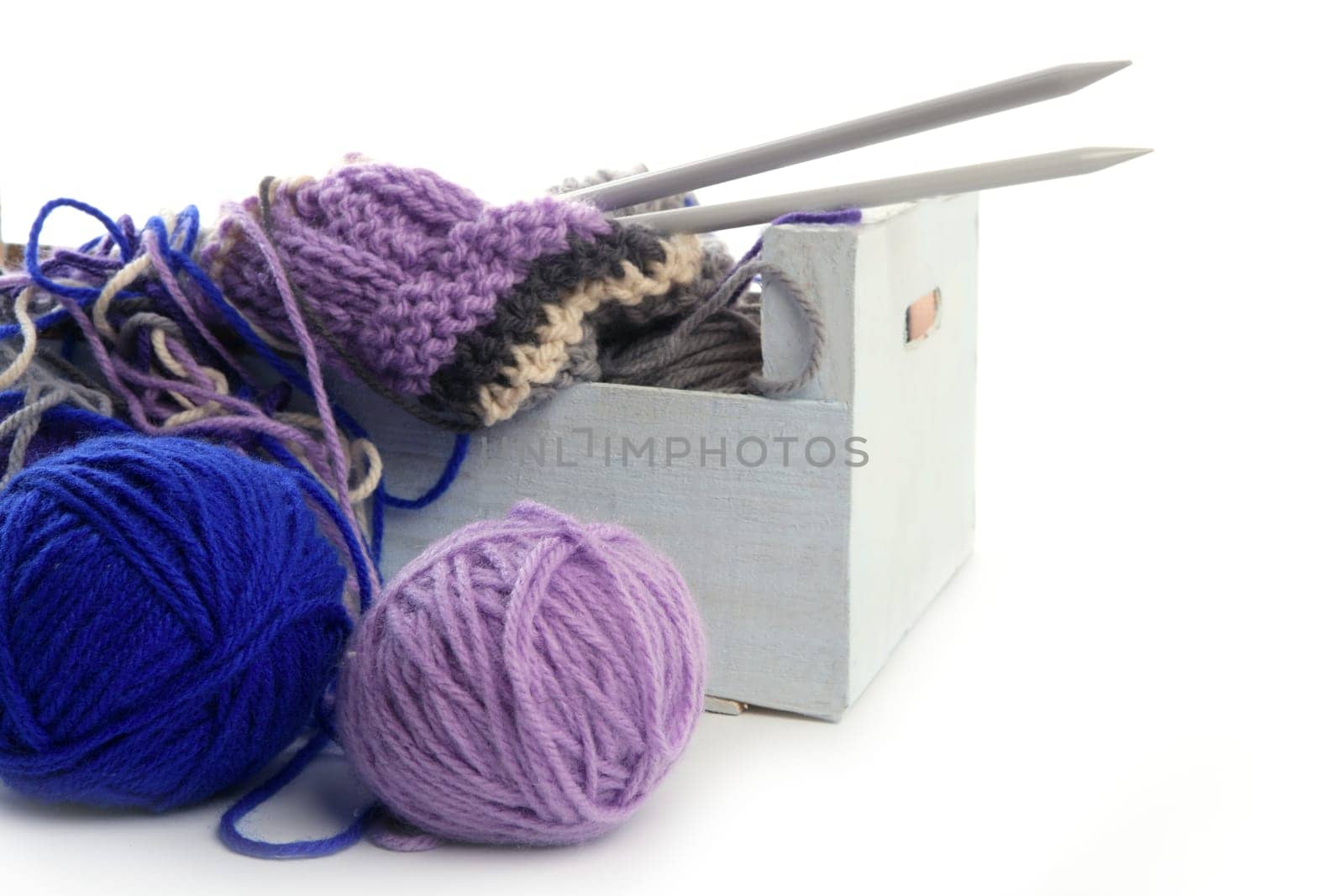 colorful knitting tools with wool thread balls