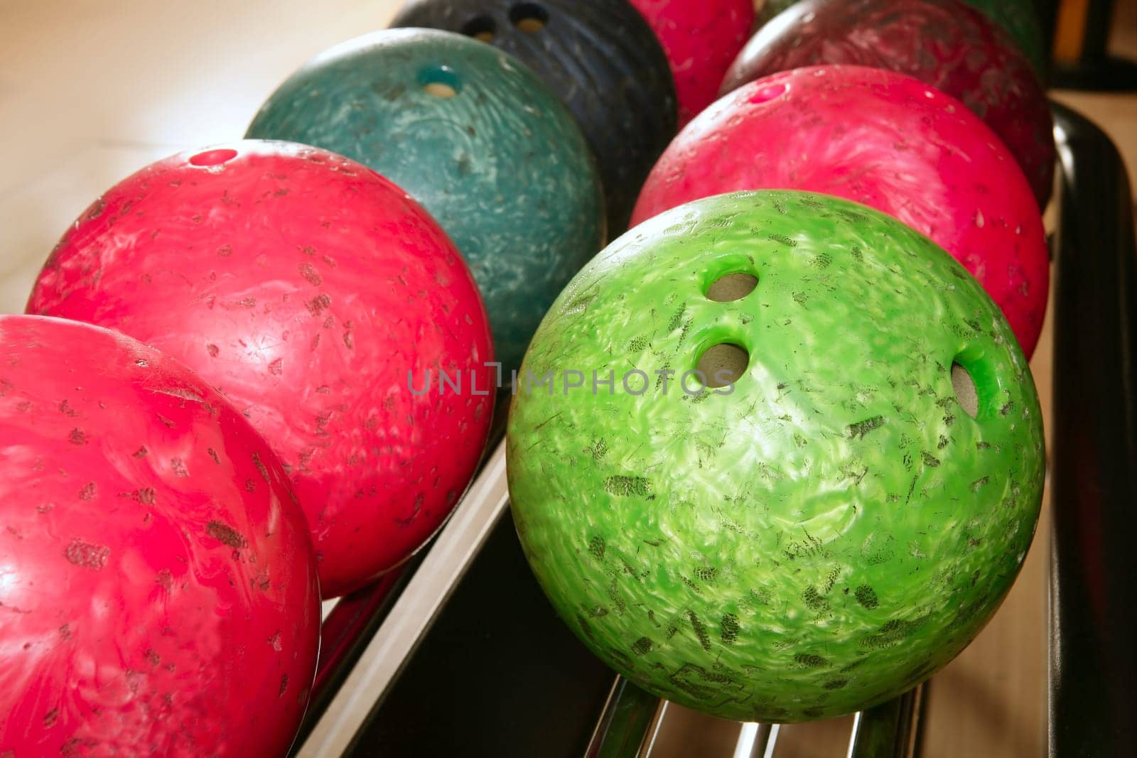 Bowling balls red green closeup row detail