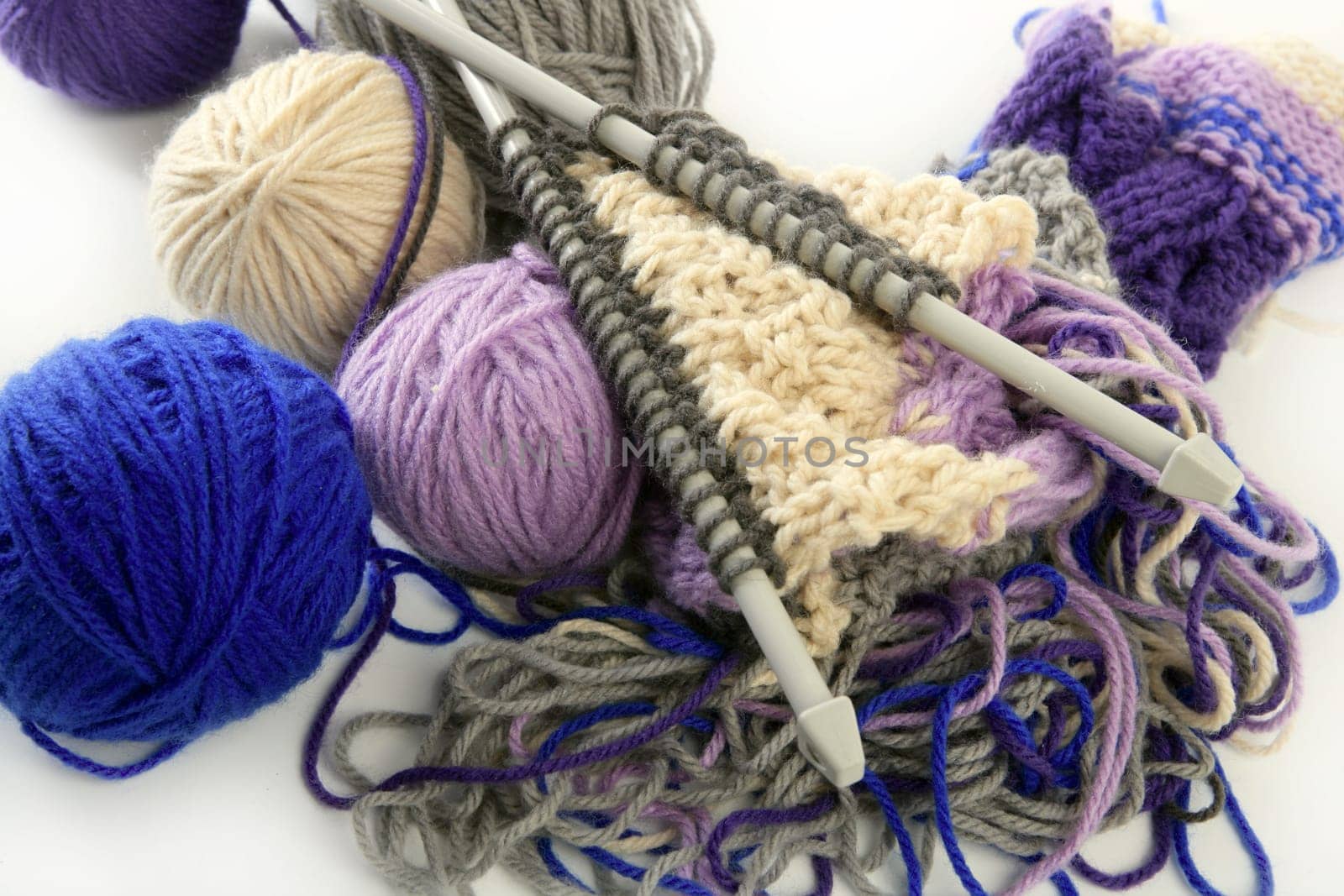 colorful knitting tools with wool thread balls