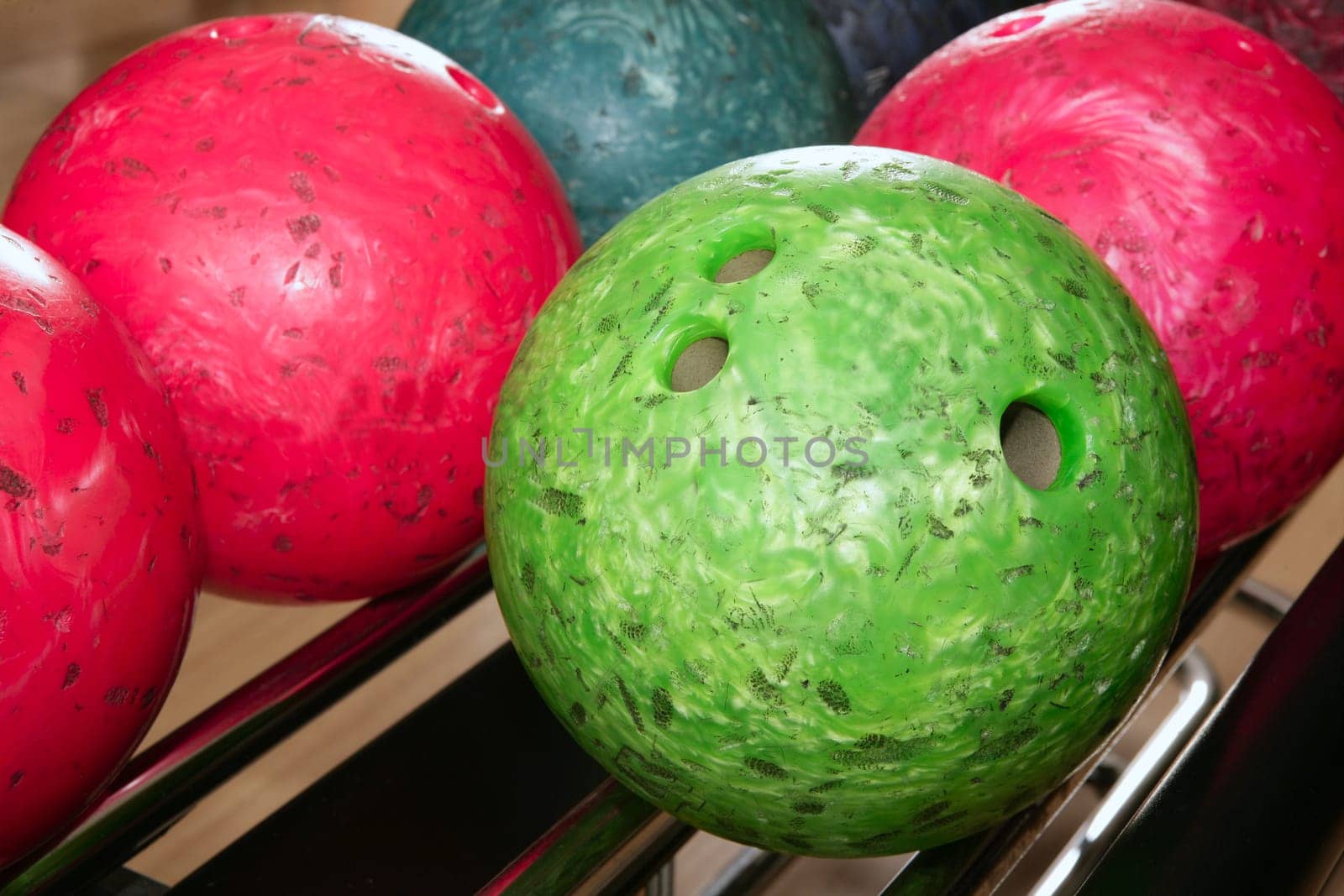 Bowling balls red green closeup row detail