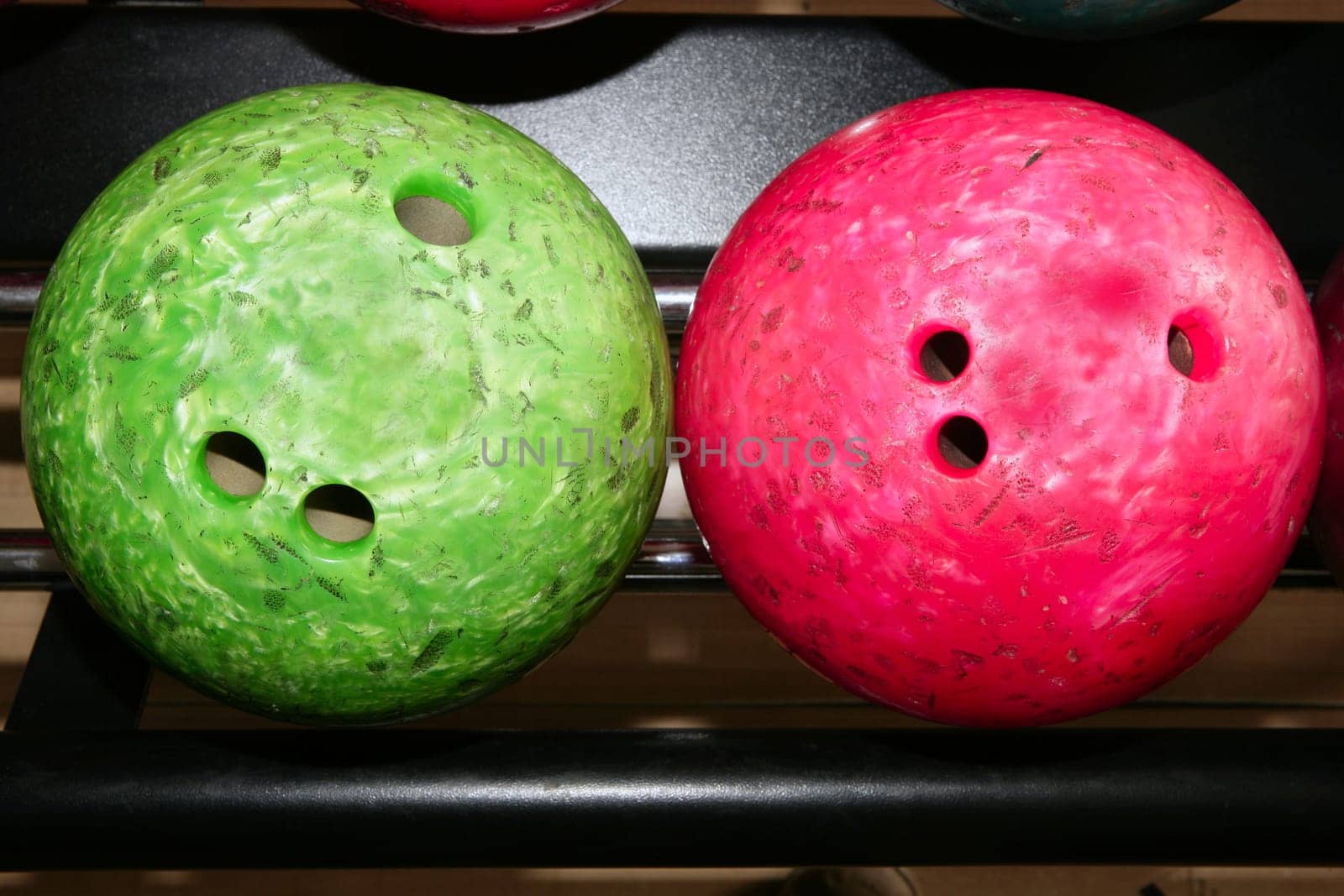 Bowling balls red green closeup row detail