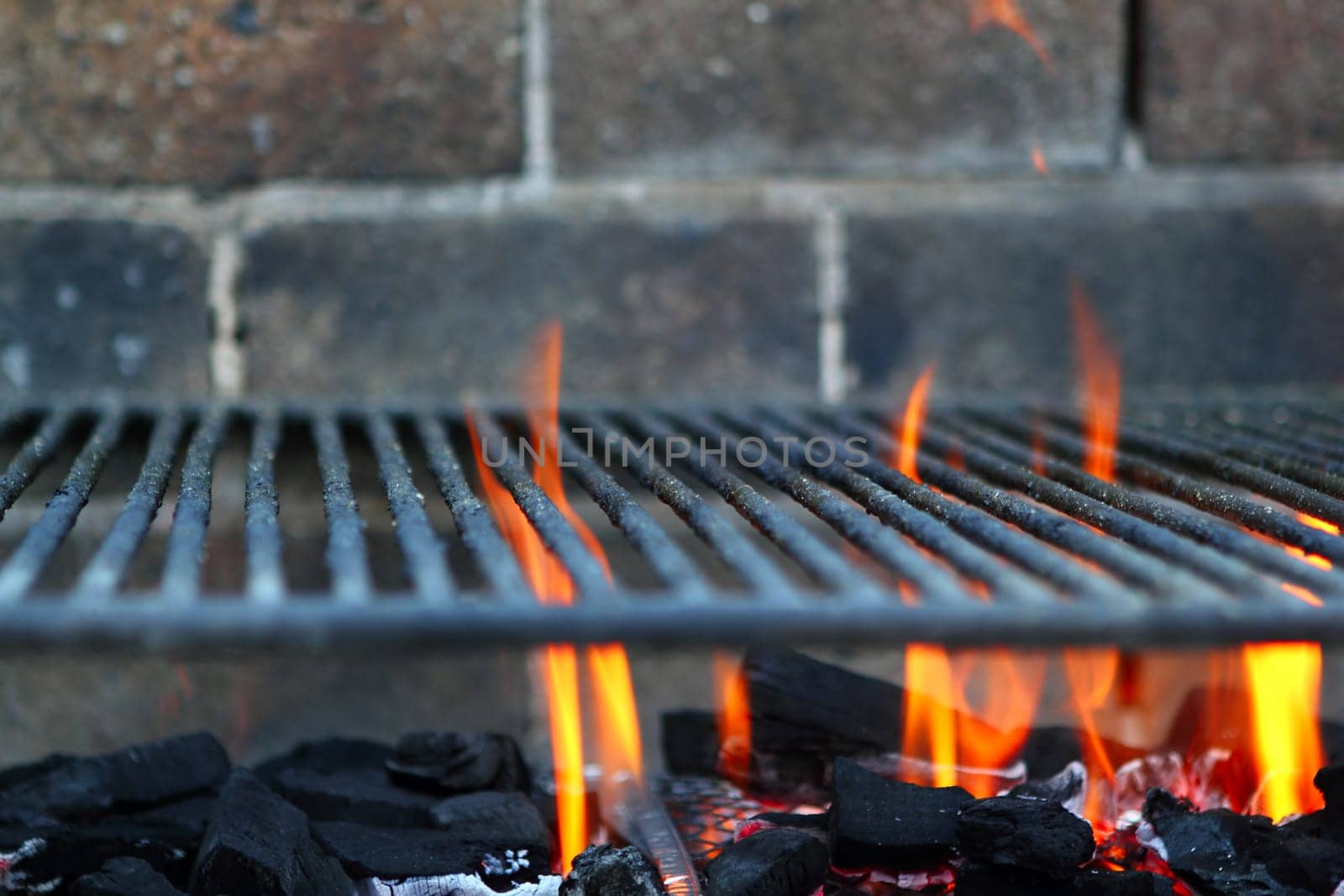 Bar b cue barbecue fire BBQ coal fire iron grill brick wall