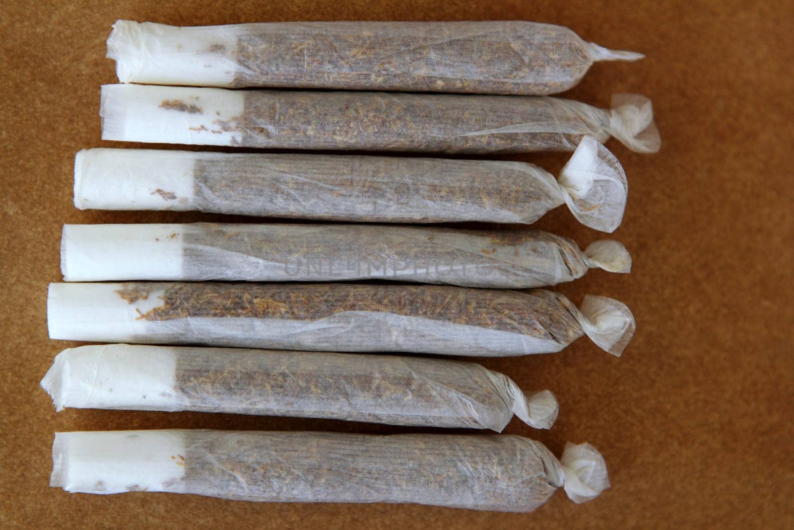 joint cigarettes hand rolled in row tobacco closeup