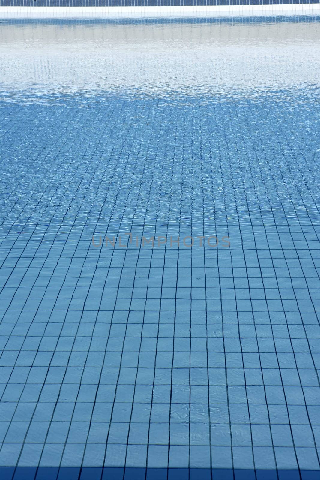 Blue tiles pool  water waves perspective summer background