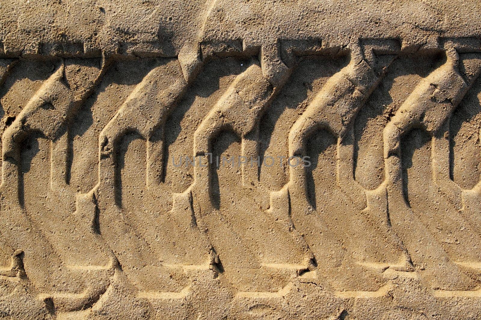 tractor tires pneus footprint printed on beach sand