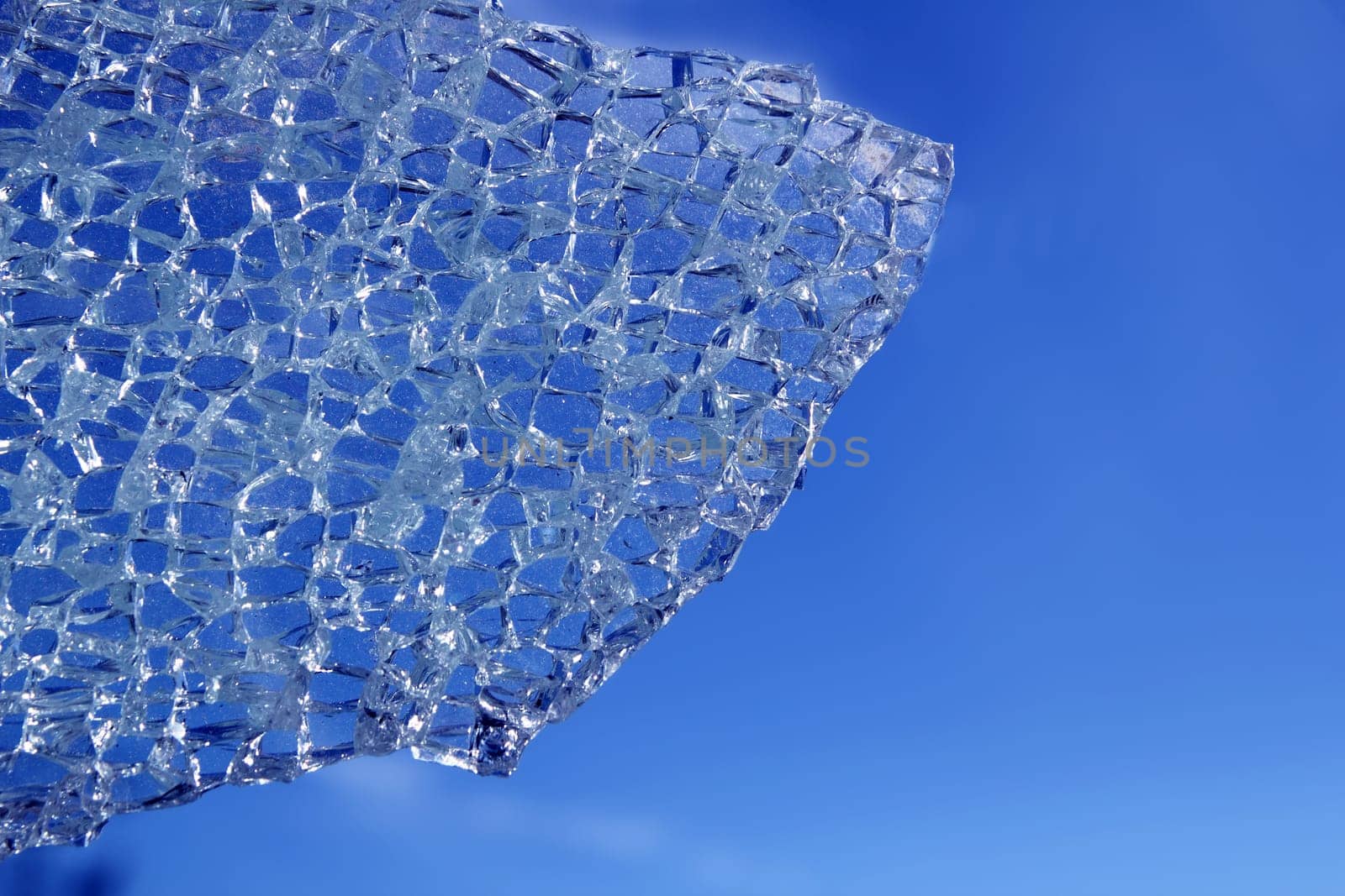 broken glass cracked over blue sky background