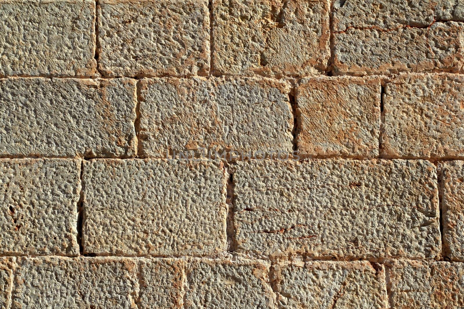 Castle masonry wall carved stone rows pattern ancient texture from Spain